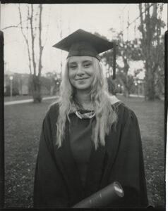 Headshot of Ella May McNiece wearing a cap and gown. The photo is in black and white.