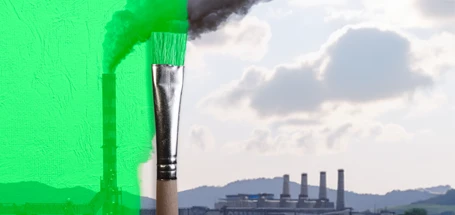 Smokestack and horizon with factory buildings in background with paintbrush covering it all with green paint